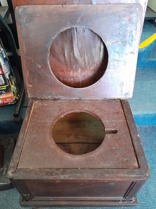 Secondhand vintage wooden potty, hinged lid open, circular cutouts, needs TLC, available at Die Skatkis.