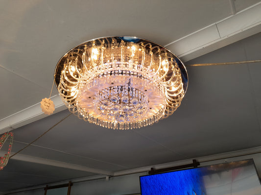 Crystal ceiling light with multiple settings, remote-controlled, featuring intricate design and warm illumination, perfect for elegant interiors.
