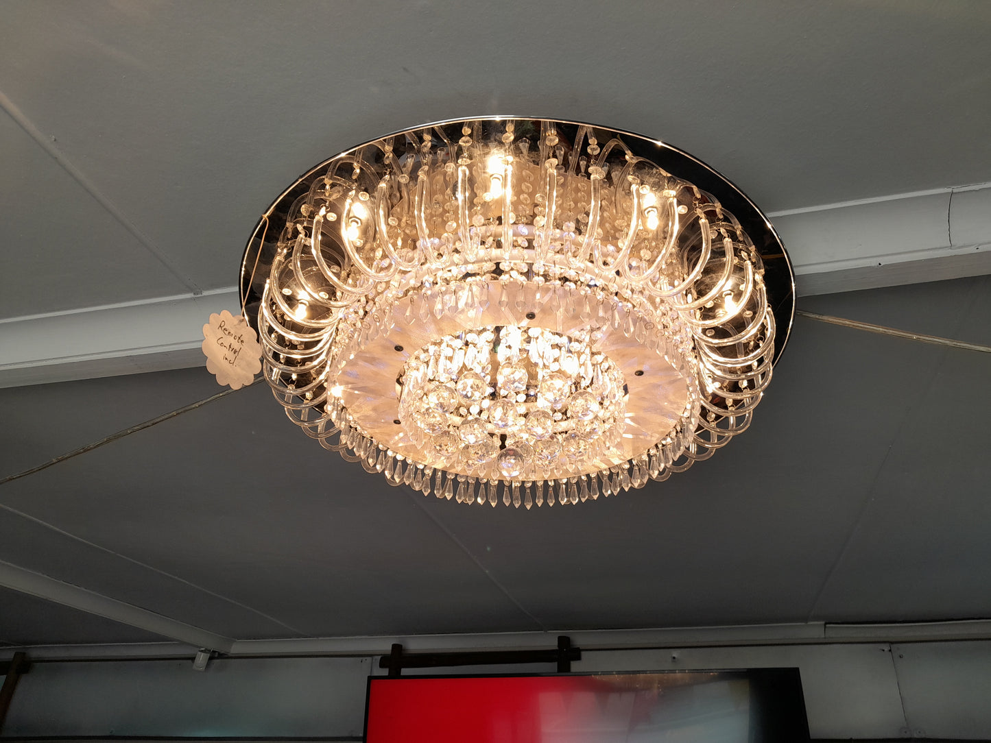 Crystal chandelier with multiple layers and remote control functionality. Adds a touch of sophistication. Available at Die Skatkis.
