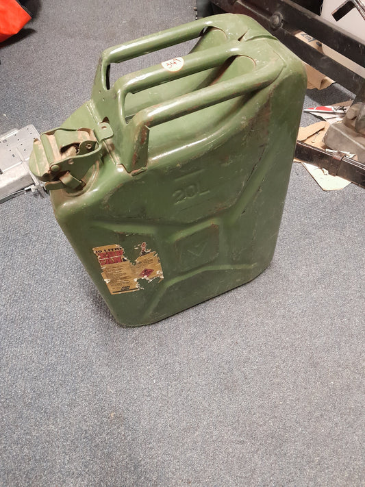 A 20-liter green jerry can on the floor, ideal for storing and transporting liquids like fuel and water. Perfect for outdoor use.