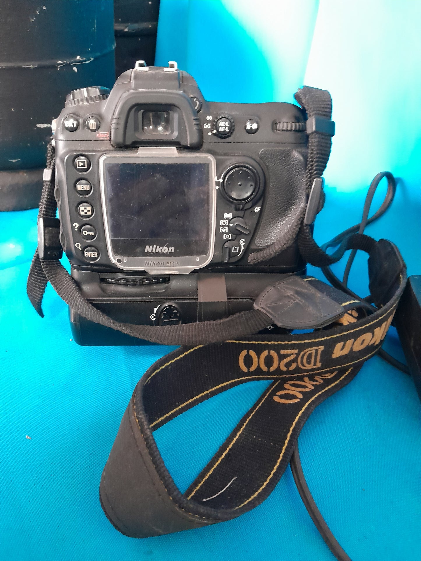 Detailed view of Nikon D200 camera with strap and battery, great for amateur and professional photographers