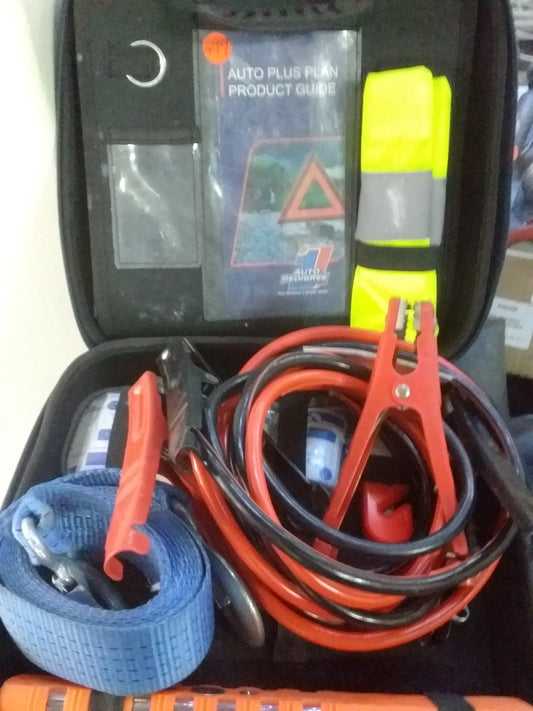 Auto Pedigree Emergency Car Kit from Die Skatkis, includes jumper cables, safety vest, towing strap, and product guide in a compact case.