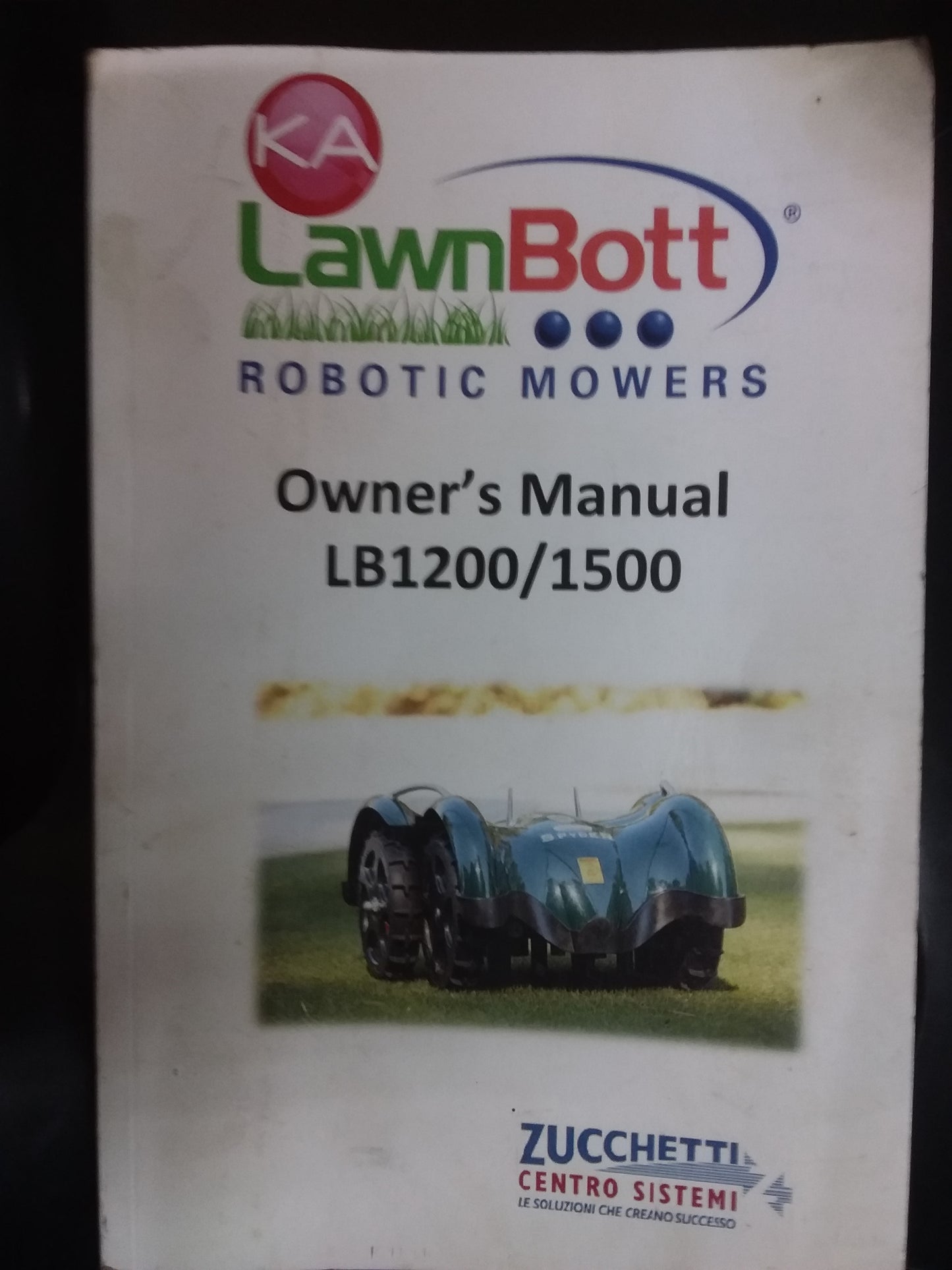 Owner's manual cover for the LawnBott LB1200/1500 robotic mowers by Zucchetti, featuring the LawnBott logo and mower image. Available at Die Skatkis.