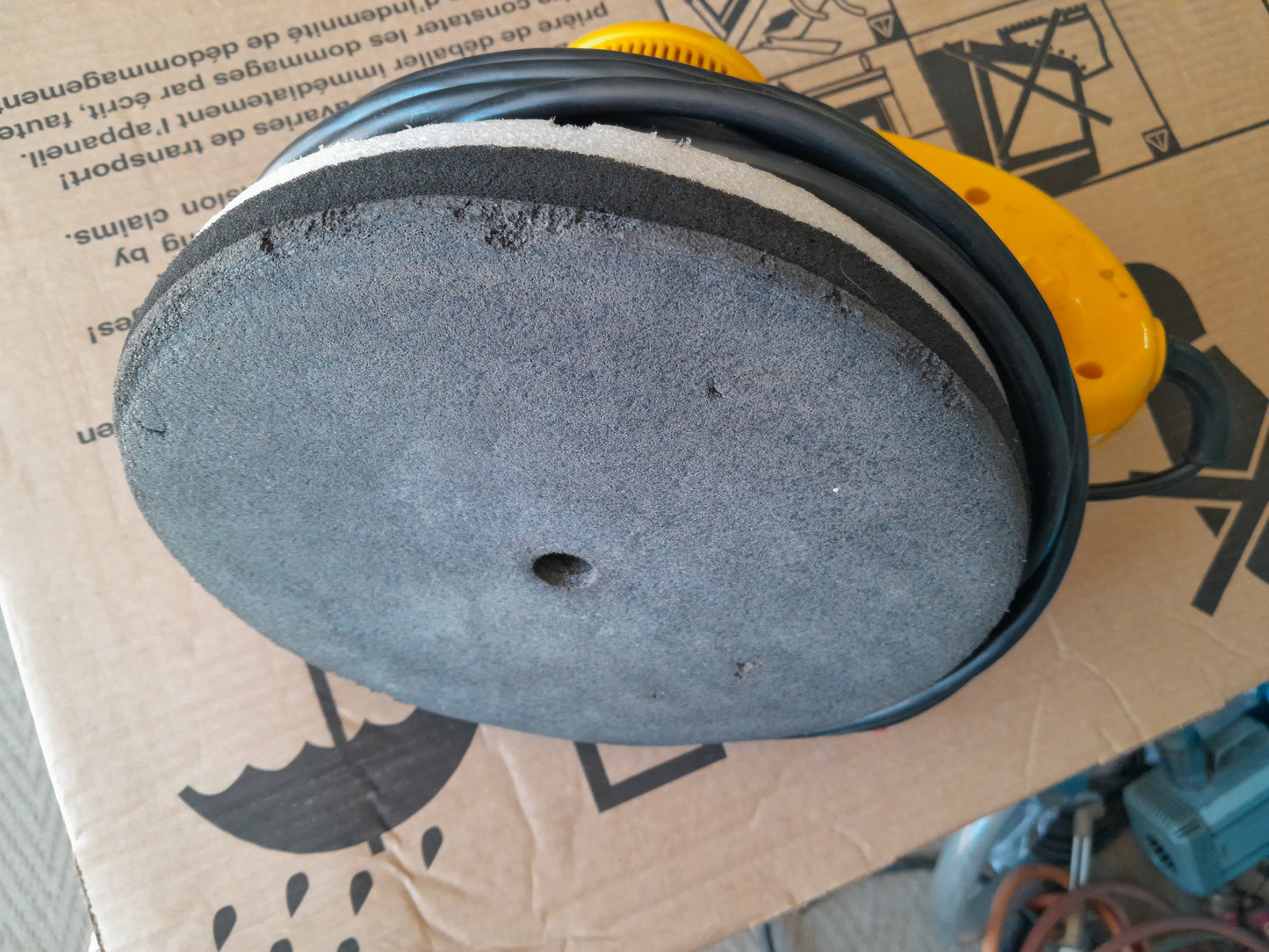 Close-up of the polishing pad on a Shield Orbital Polisher, highlighting its texture and condition.