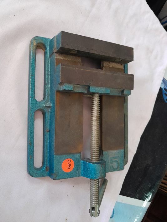 Durable cast iron drill press vice with hardened jaws for secure workpiece holding.