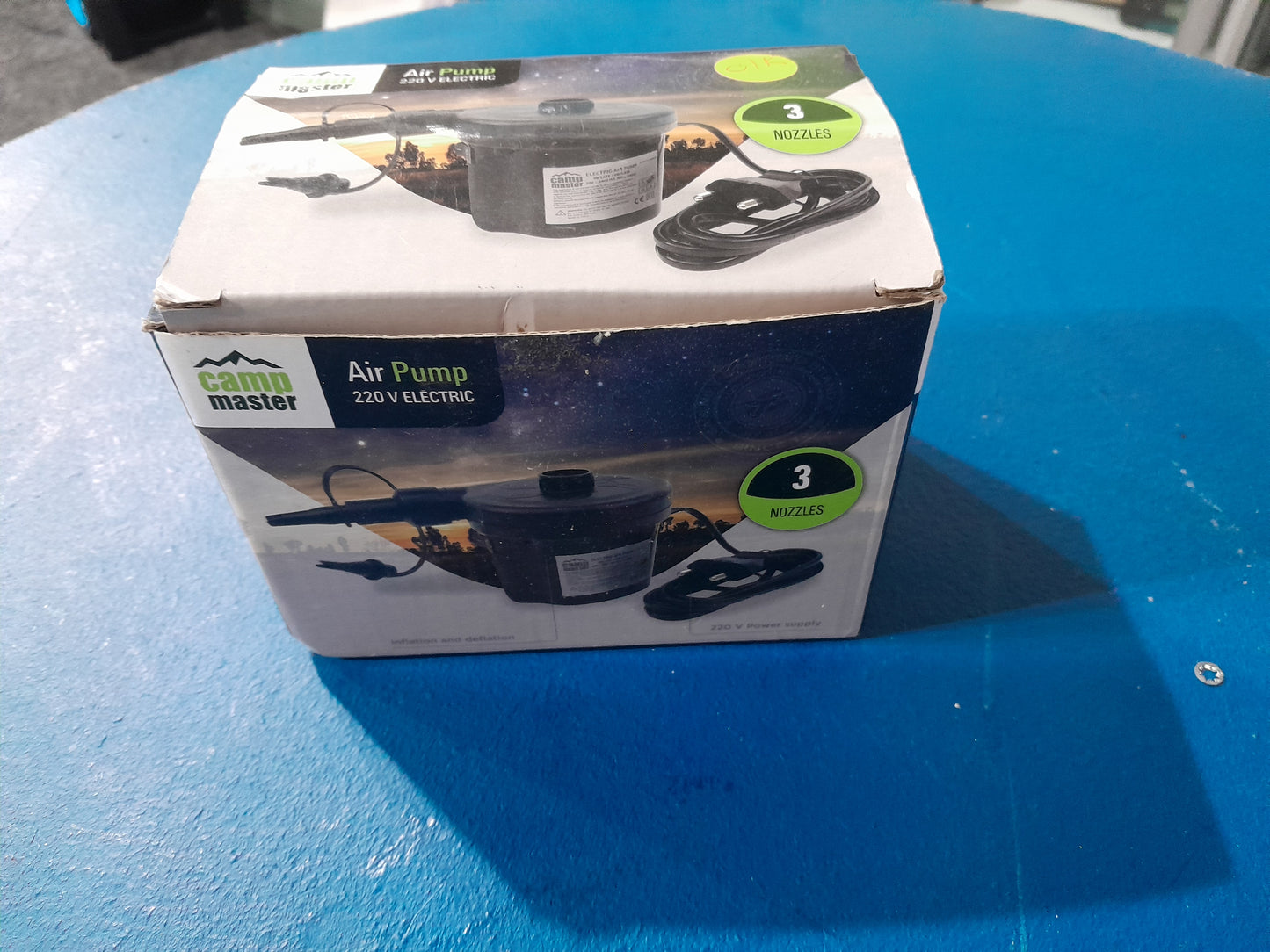 Camp Master air pump with power cord, perfect for outdoor and indoor inflating tasks.