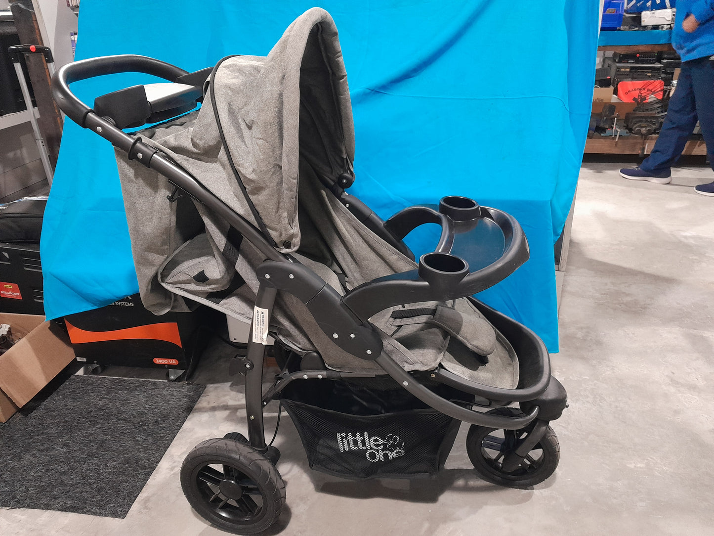 Side view of a Little One baby stroller, featuring a three-wheel design for safety and convenience.