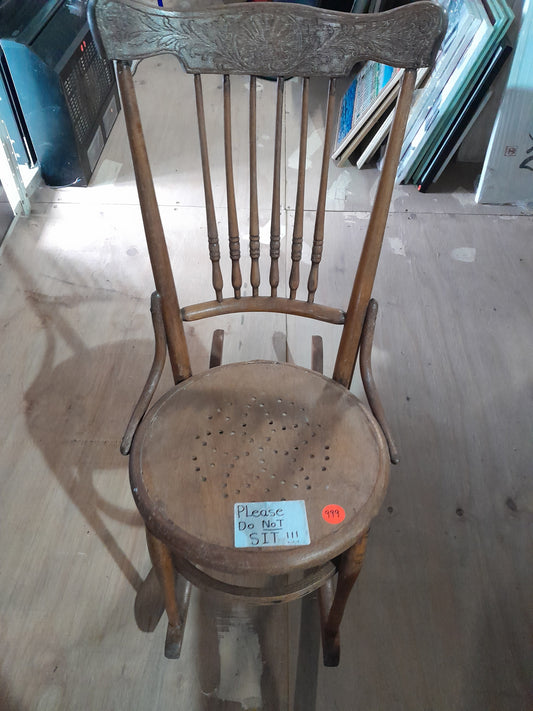 Vintage spindle back rocking chair with elegant carvings, in excellent condition, perfect for classic home decor.