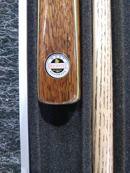 Close-up of the Weichster pool cue handle showcasing its handmade quality and logo.