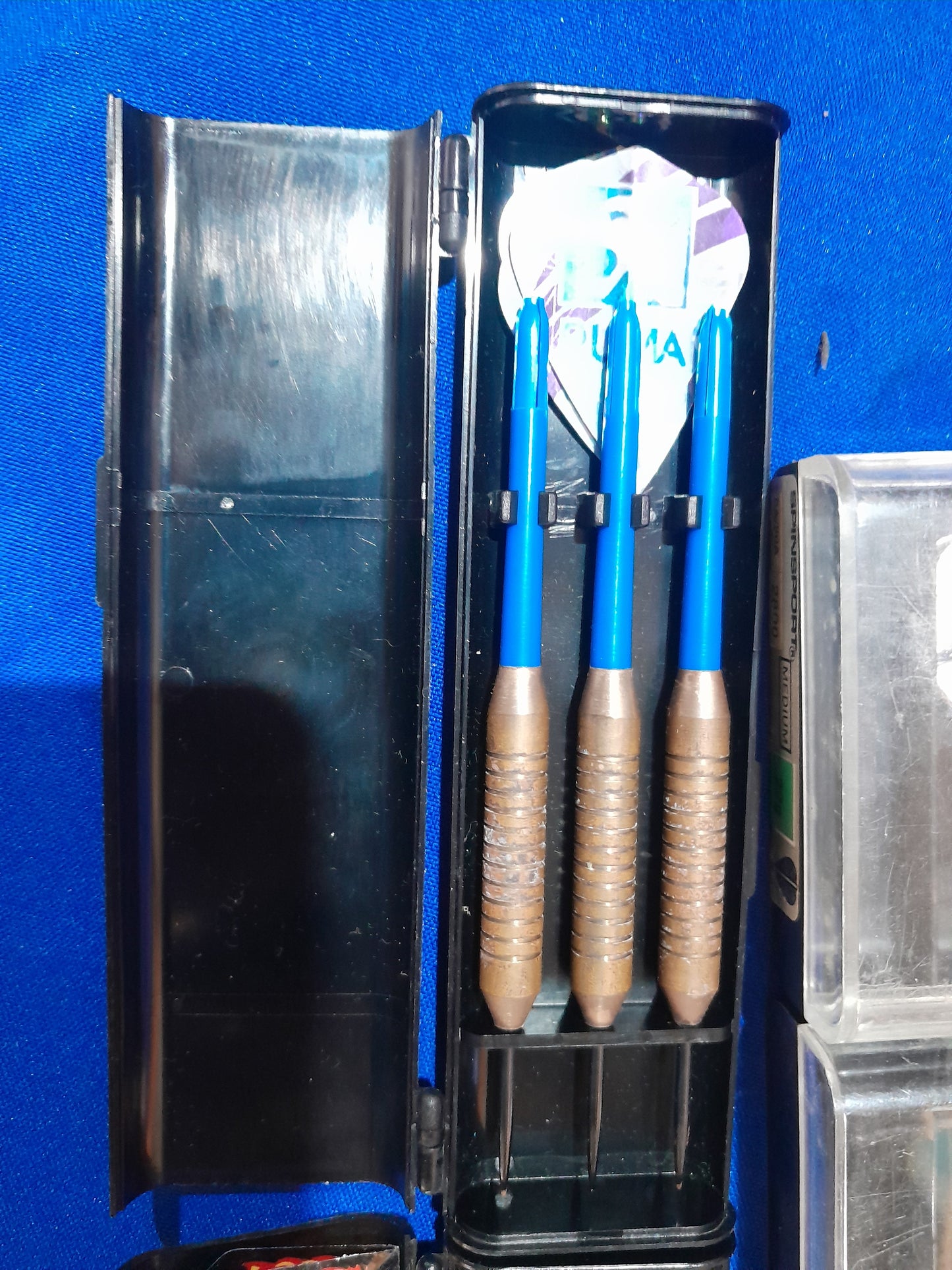 Five stylish dart sets, complete with flights and protective cases, perfect for any game room.