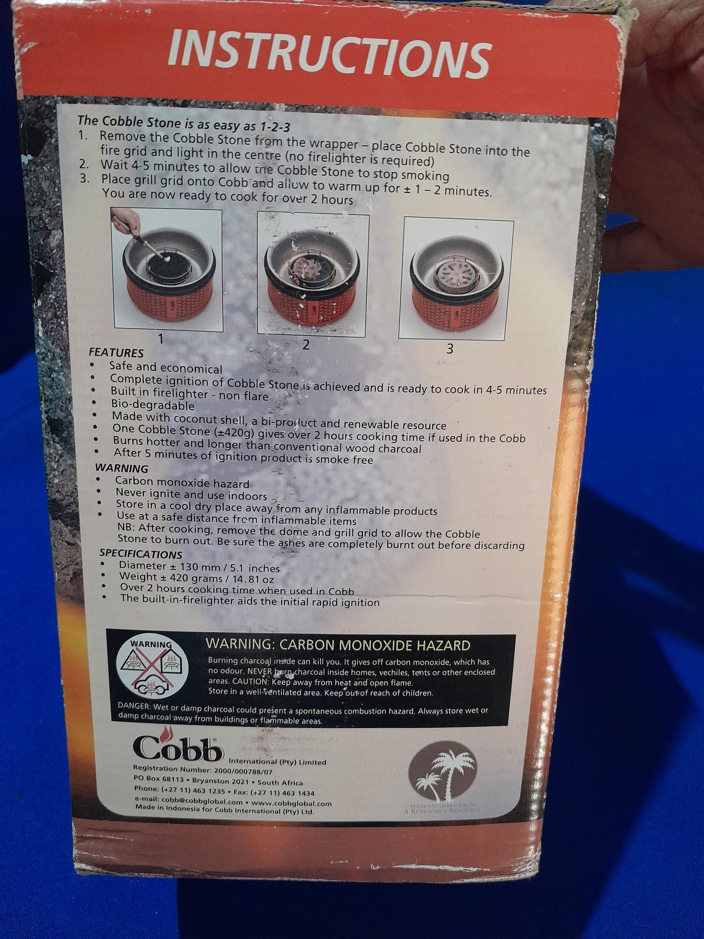 Close-up of Cobb Cobblers stone, perfect for enhancing your grilling experience with long-lasting burn.