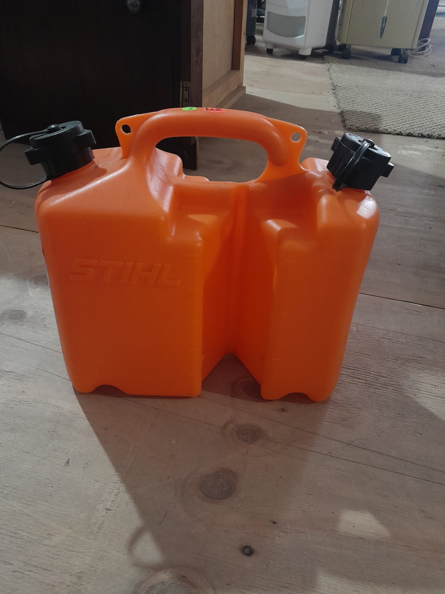 Durable orange Stihl Combi Canister, designed for easy fuel and oil transport for chainsaws.