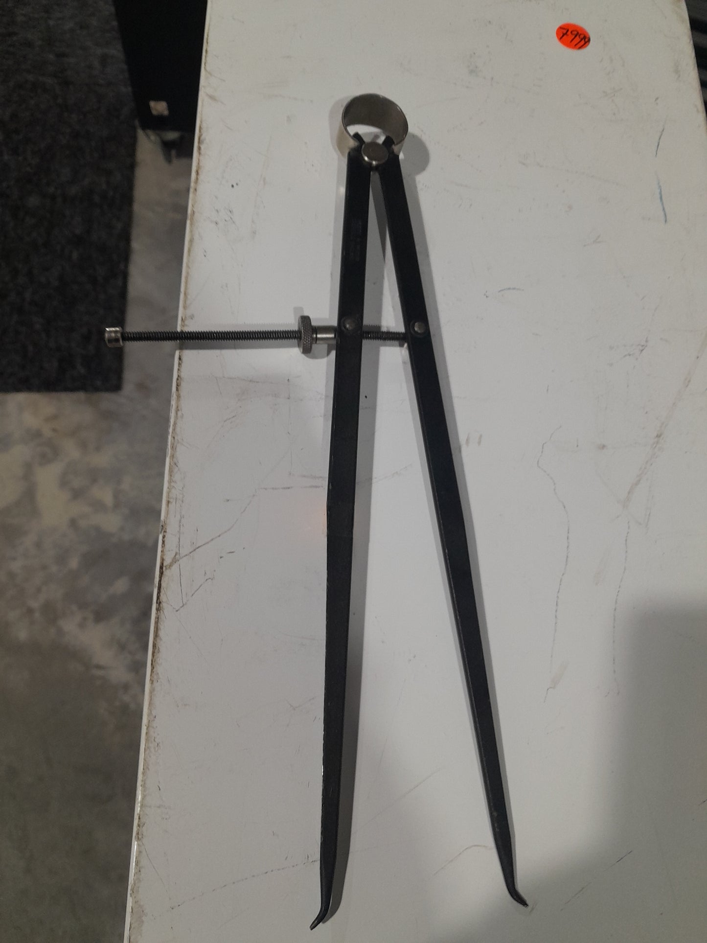 Wing divider used for accurate metalworking and drafting, perfect for artisans and hobbyists.