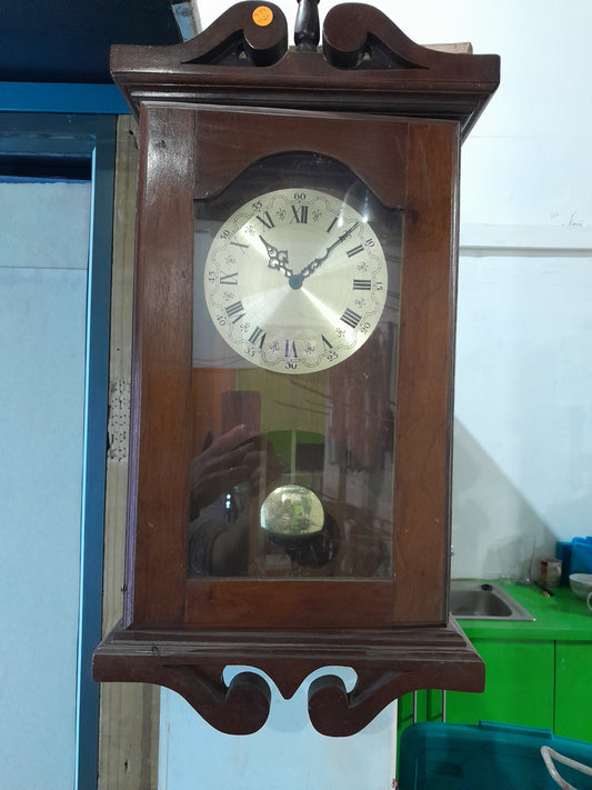 Vintage wooden clock with intricate design, perfect as a decorative piece for your home.