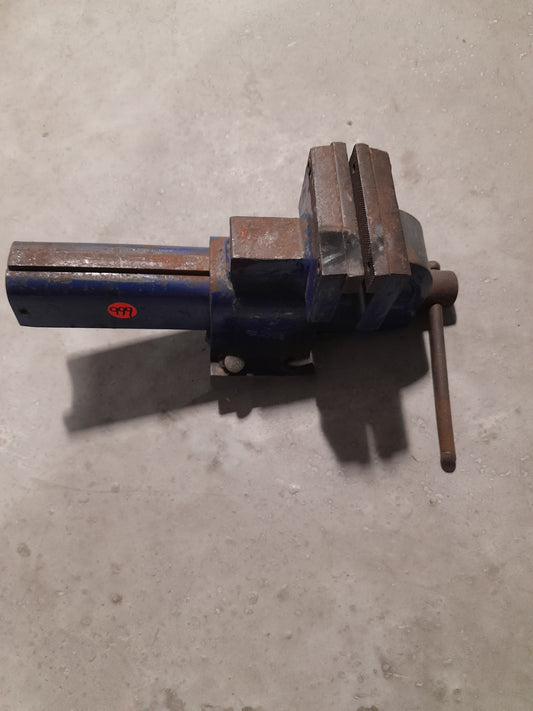 A sturdy used bench vise, ideal for securing materials during cutting, drilling, or filing tasks.