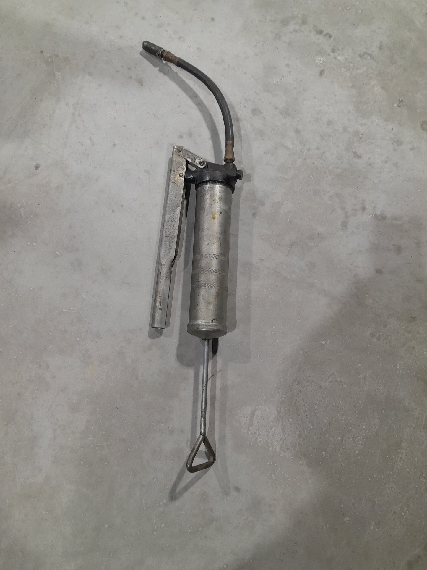 Grease gun with lever action mechanism, suitable for various maintenance applications.