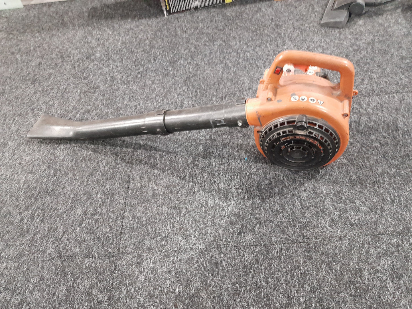 Alpha Petrol Blower in orange, perfect for clearing leaves and debris efficiently.