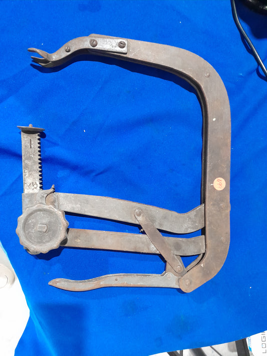 Heavy-duty valve spring compressor tool for engine maintenance and repair.