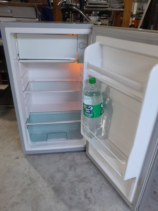 Interior view of a Salton bar fridge showcasing shelves and freezer compartment.
