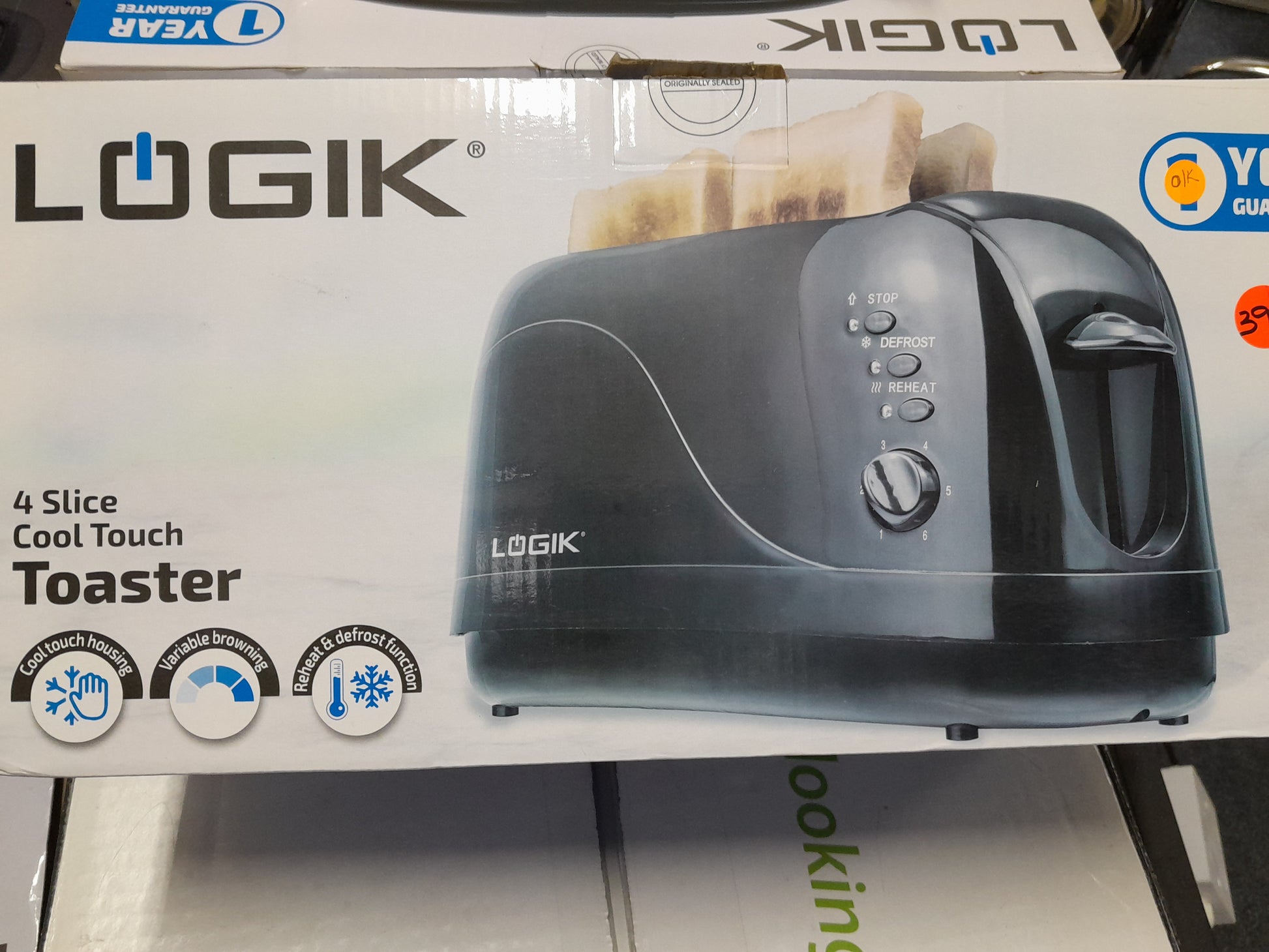 Logik 4 Slice Toaster with reheat and defrost functions, cool touch housing, and variable browning control, in excellent working condition.