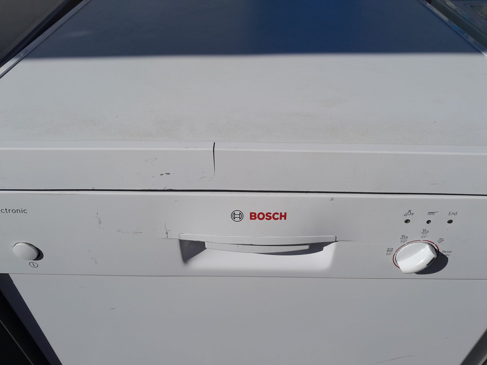 Close-up of Bosch dishwasher control panel showing settings for quiet operation.