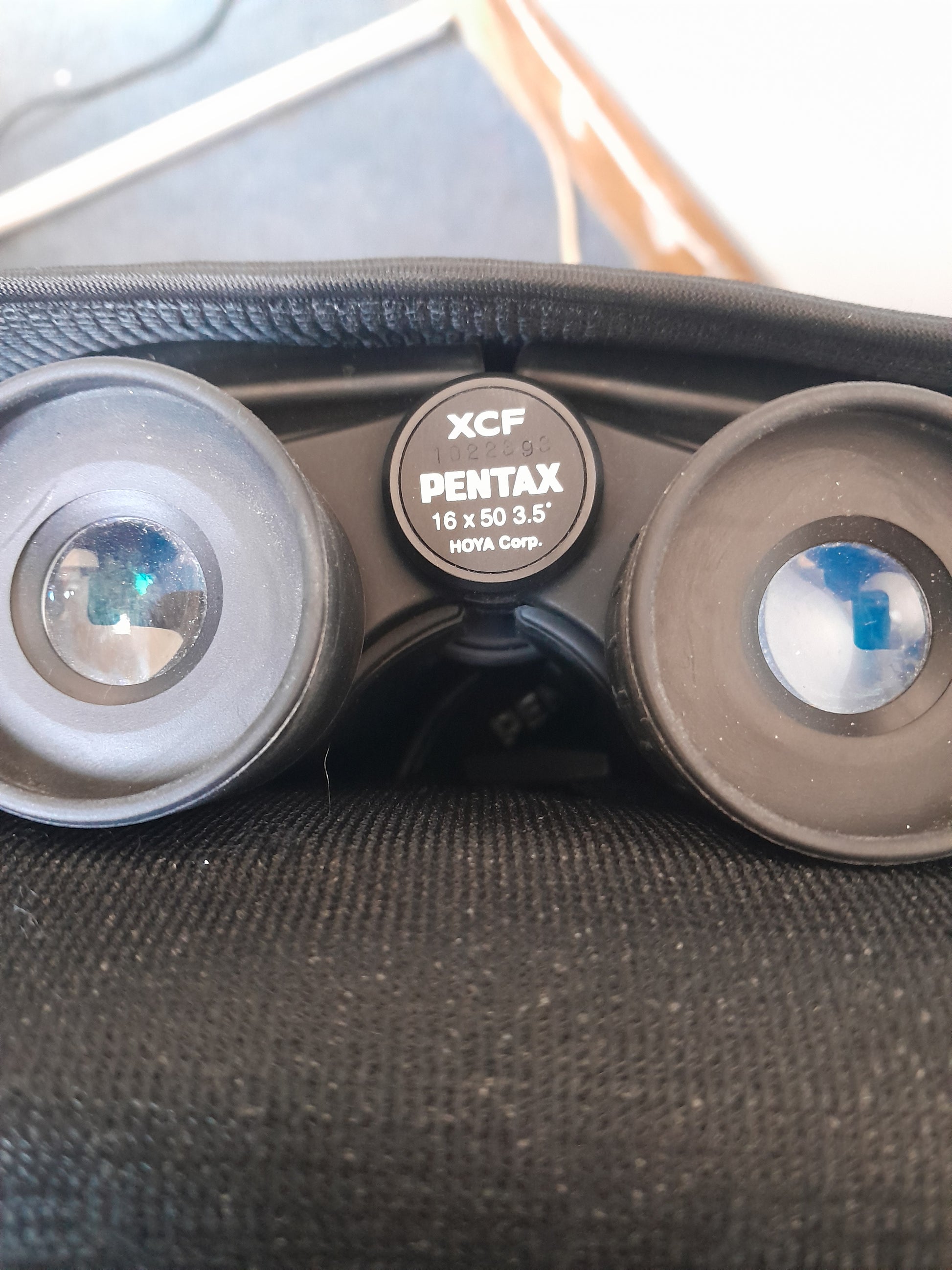 Close-up view of Pentax XCF 16x50 binoculars with clear model information, housed in a black fabric case, available at Die Skatkis.