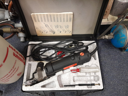 Heiniger electric hand shear in a case with accessories, ideal for shearing livestock, available at Die Skatkis secondhand store.