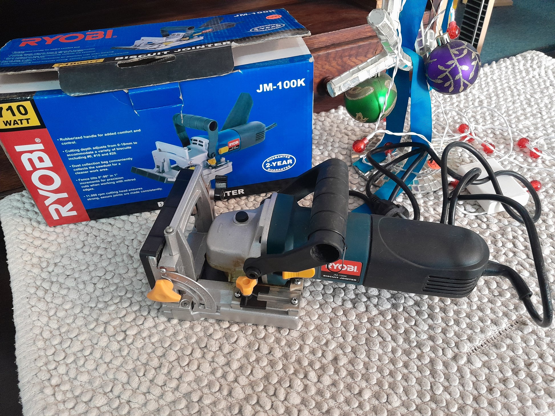 Ryobi Biscuit Jointer JM-100K with 710W power, adjustable cutting depth, and 11,000 rpm cutting head, shown with original box.