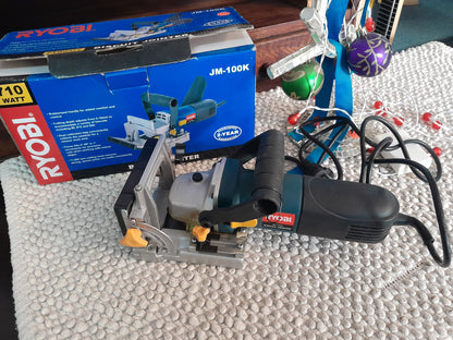 Ryobi Biscuit Jointer JM-100K with 710W power, adjustable cutting depth, and 11,000 rpm cutting head, shown with original box.