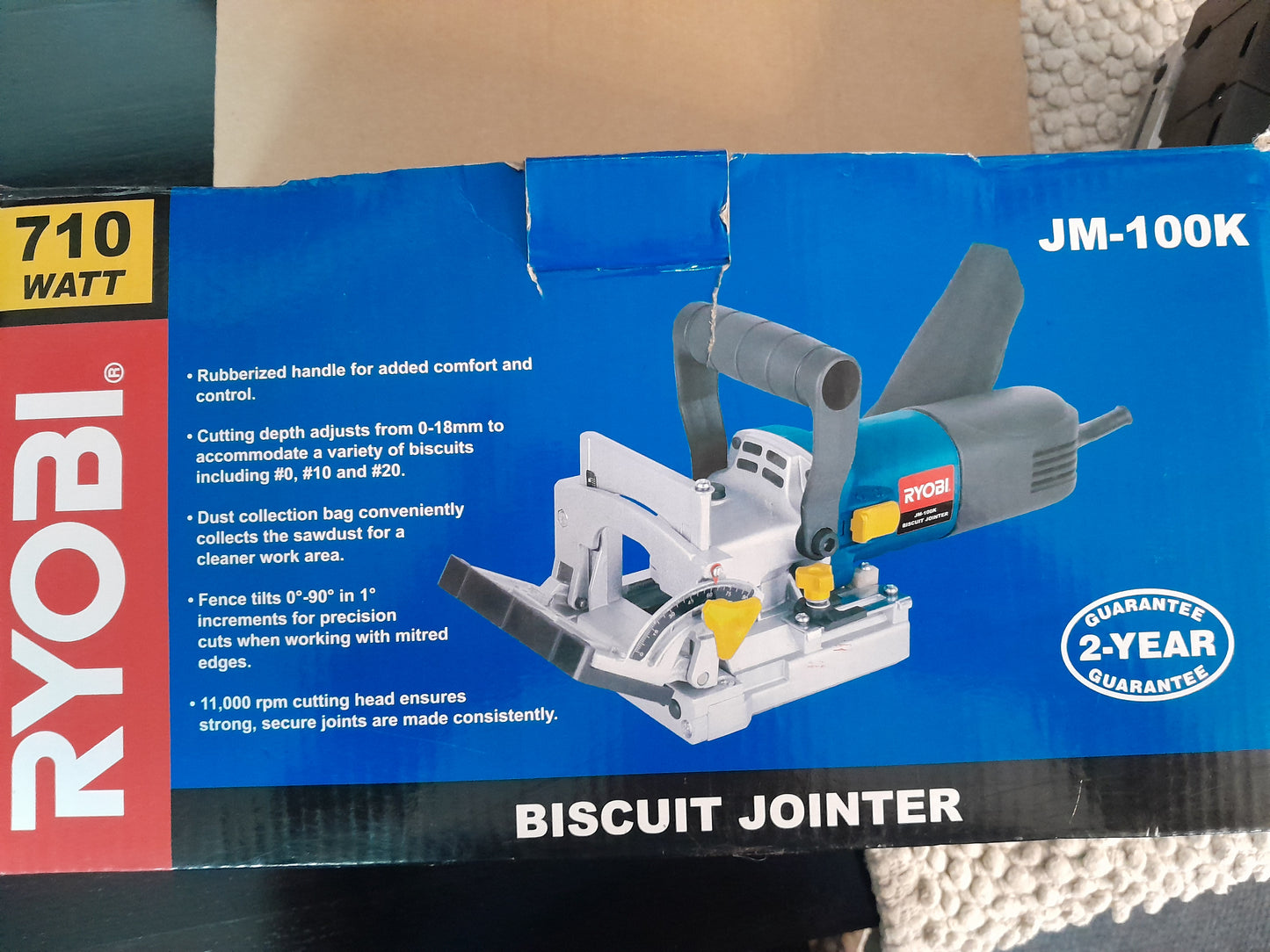 Ryobi JM-100K Biscuit Jointer package highlighting features such as 710W motor, and adjustable cutting depth.