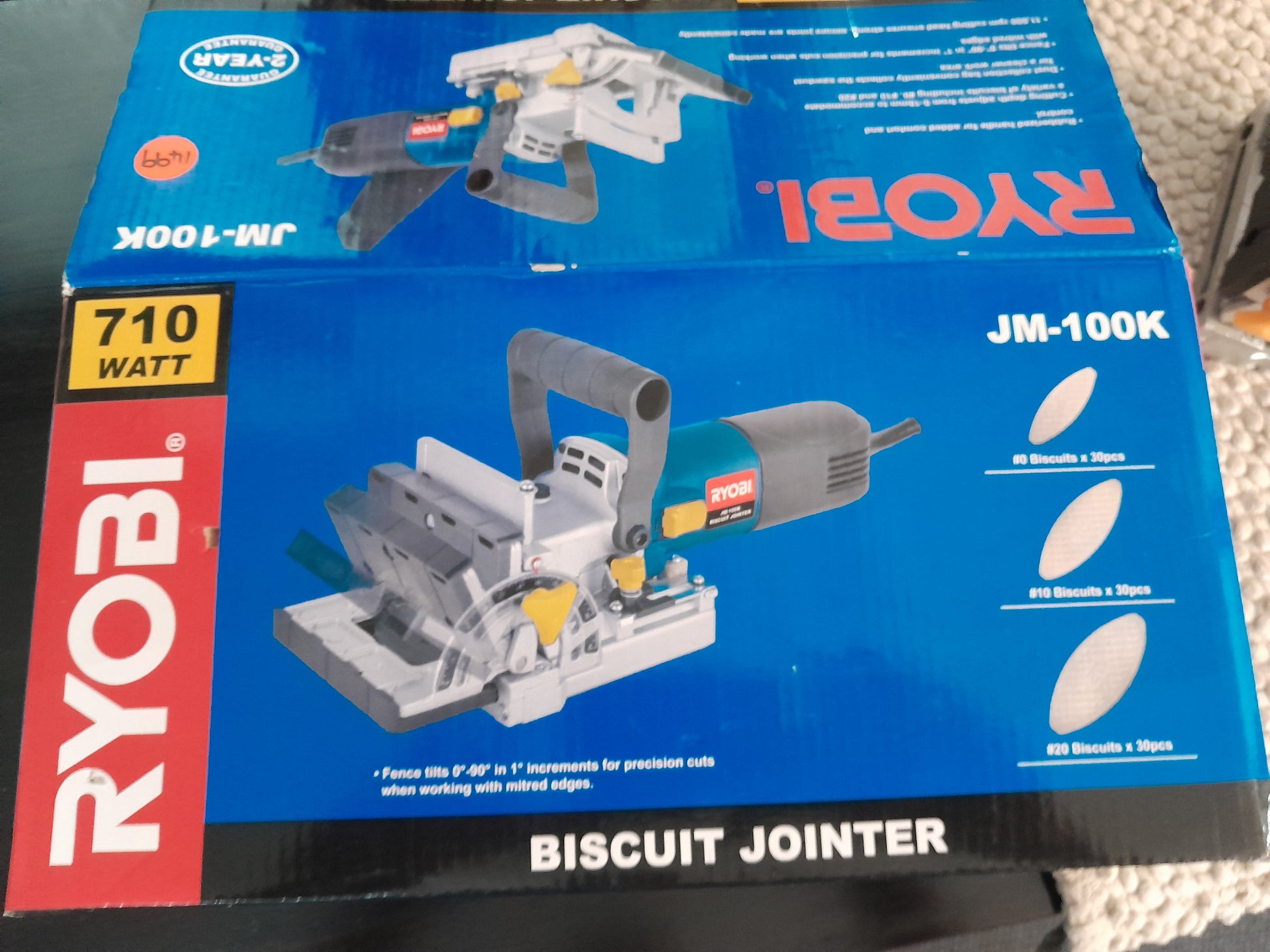 Ryobi JM-100K Biscuit Jointer packaging, highlighting its 710W motor, and adjustable fence for precision cuts.