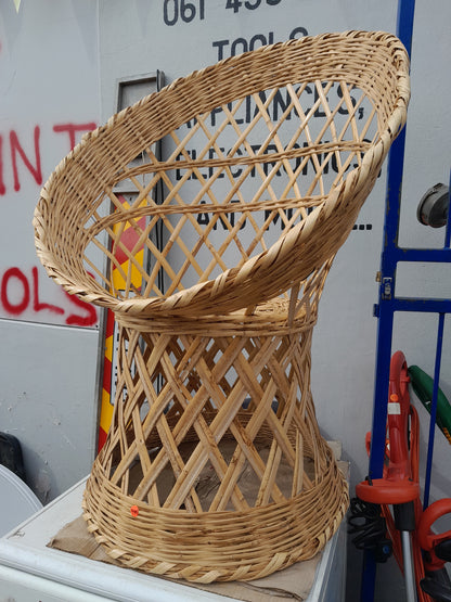 Handcrafted wicker chair with intricate lattice pattern, perfect for any patio or lounge. Find it at Die Skatkis.