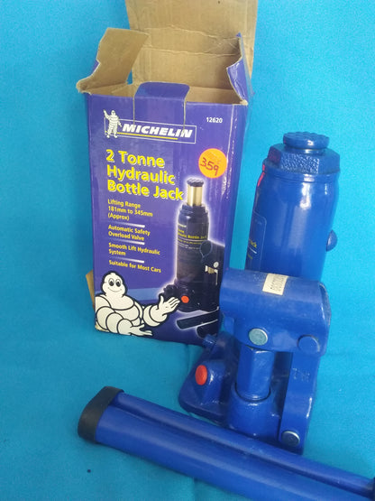 "Michelin 2 Tonne Hydraulic Bottle Jack with lifting range 181mm to 345mm, shown with blue jack and purple box featuring the Michelin logo and mascot.