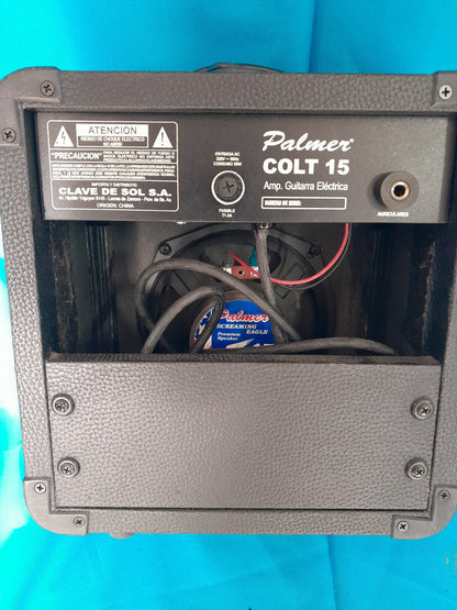 Back view of Palmer Colt 15 Guitar Amplifier, partially open to show internal components like wires and a speaker.