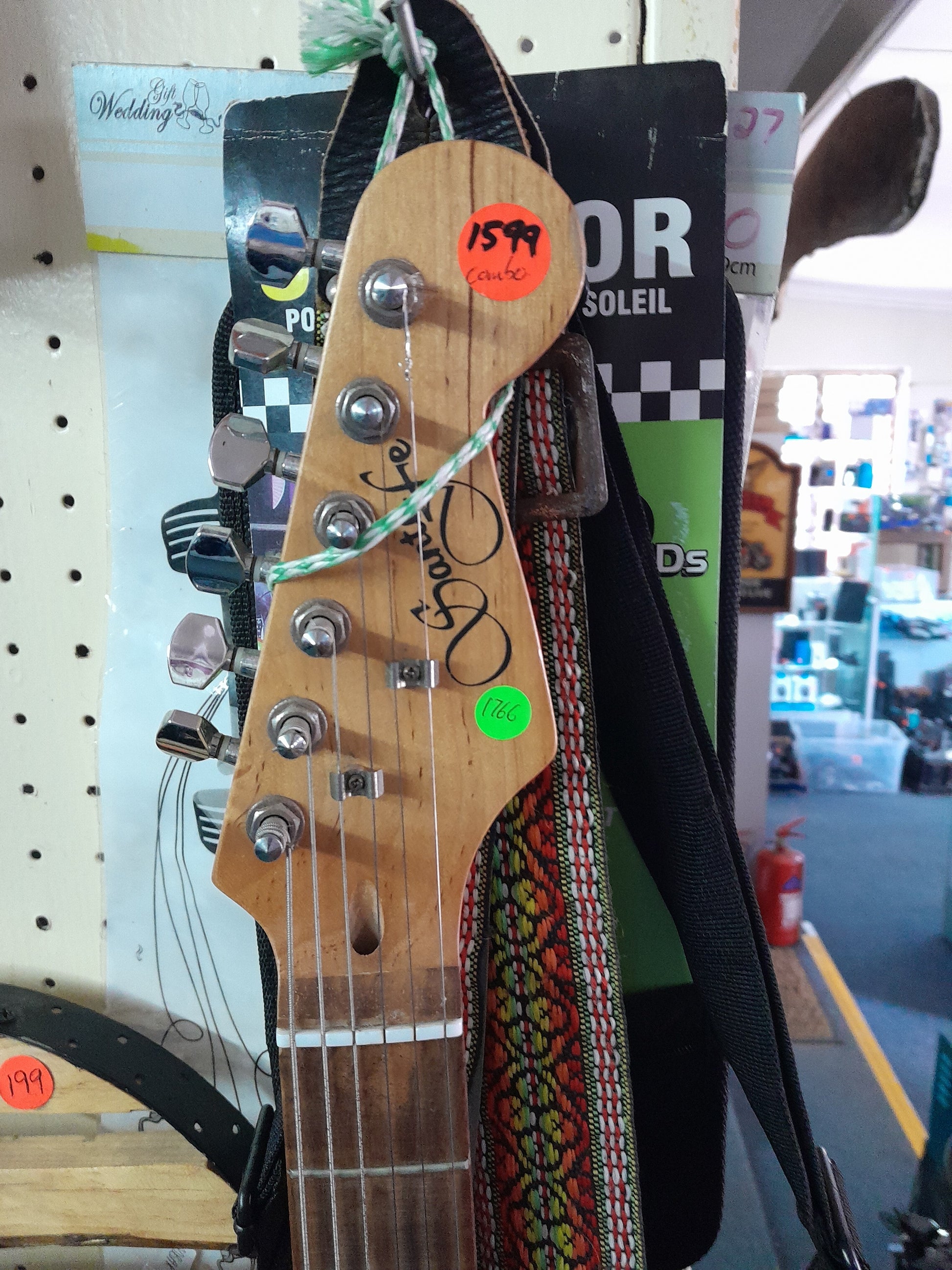 3-tone Santa Fe electric guitar ready for sale in a secondhand shop, perfect for aspiring musicians.
