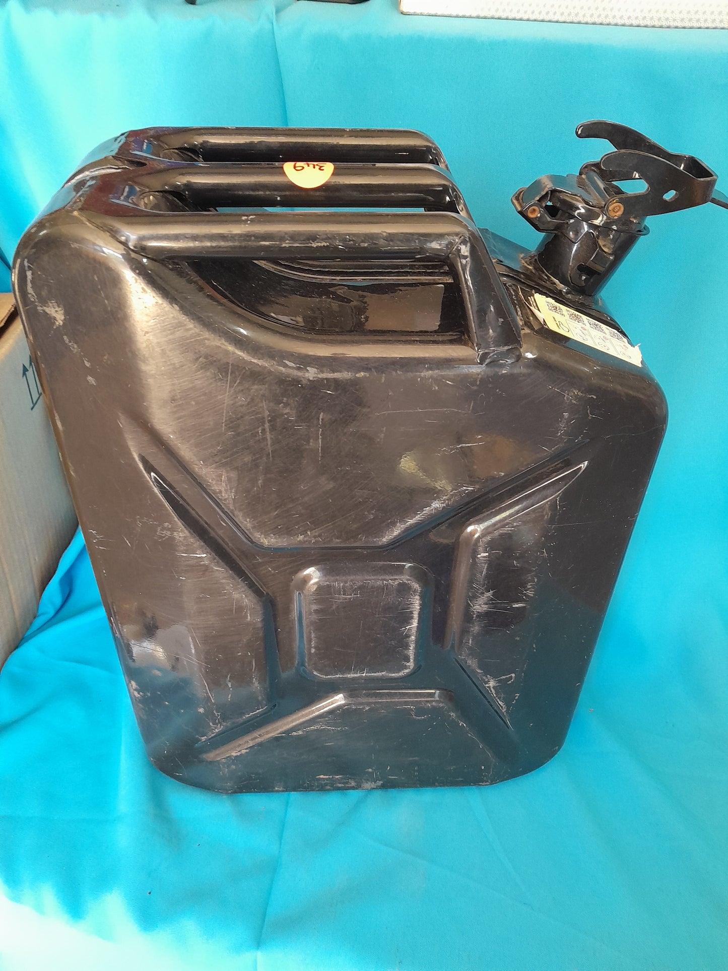 Black 20L Jerry can in good condition with a secure cap, ideal for storing petrol or diesel, available at Die Skatkis.