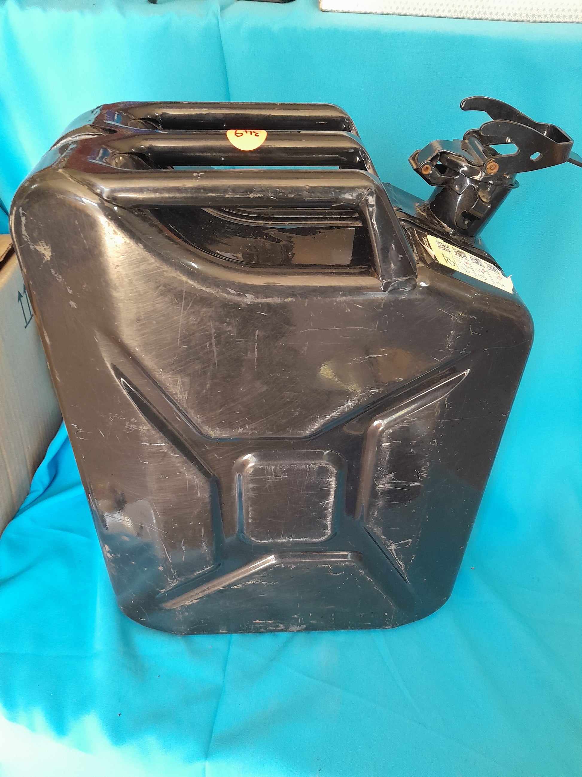 Black 20L Jerry can in good condition with a secure cap, ideal for storing petrol or diesel, available at Die Skatkis.