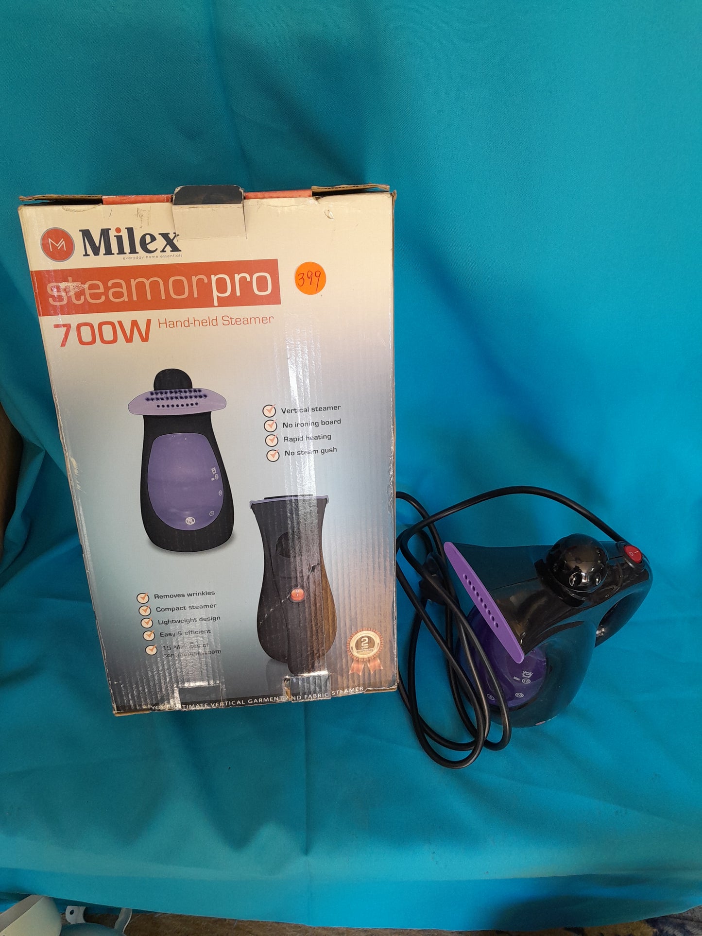 Milex Steamorpro Hand-held Steamer, 700W, with purple handle and black body, highlighted features on packaging.