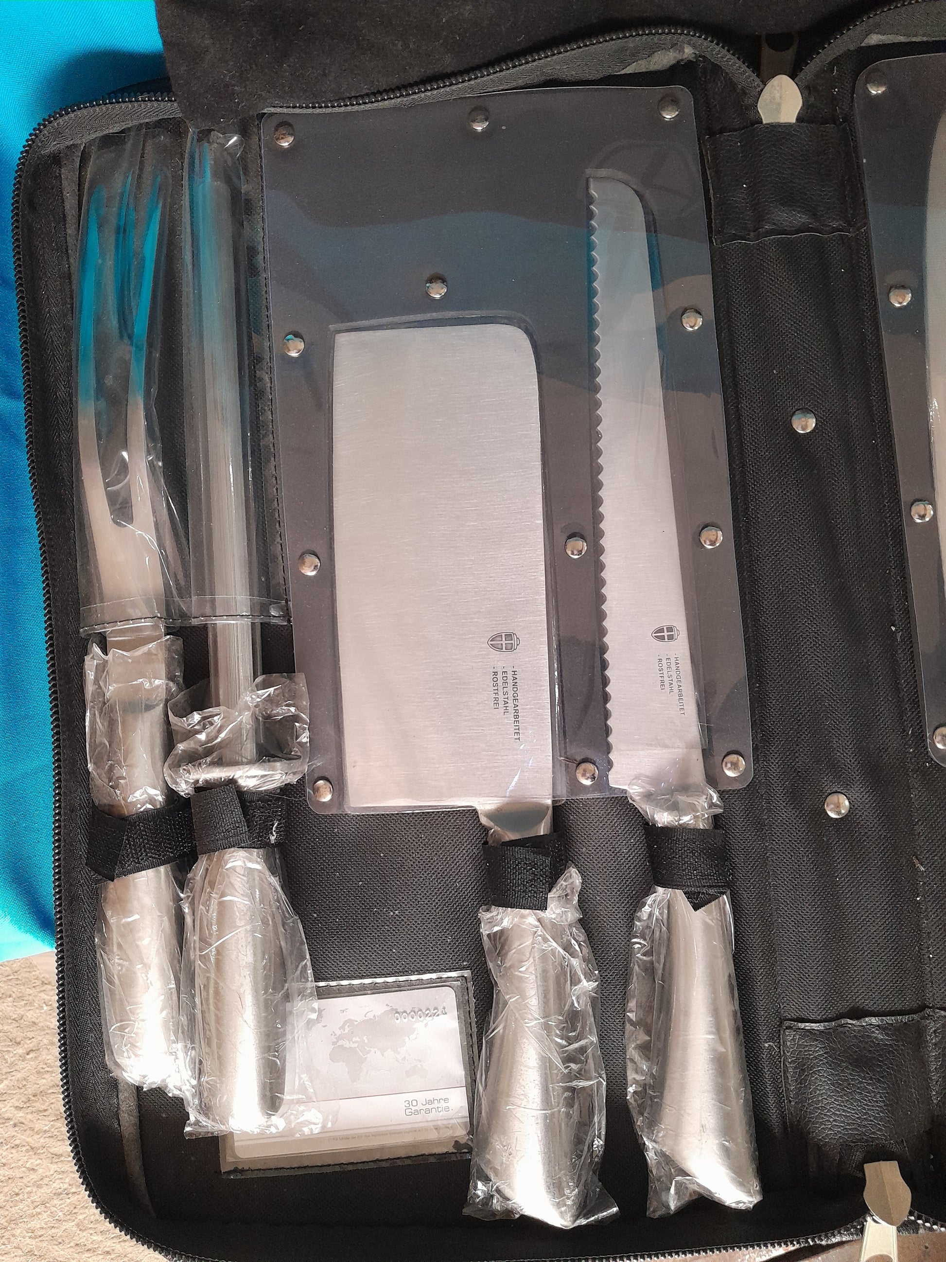 Professional kitchen knife set featuring a chef's knife, cleaver, and more in a compact storage case.