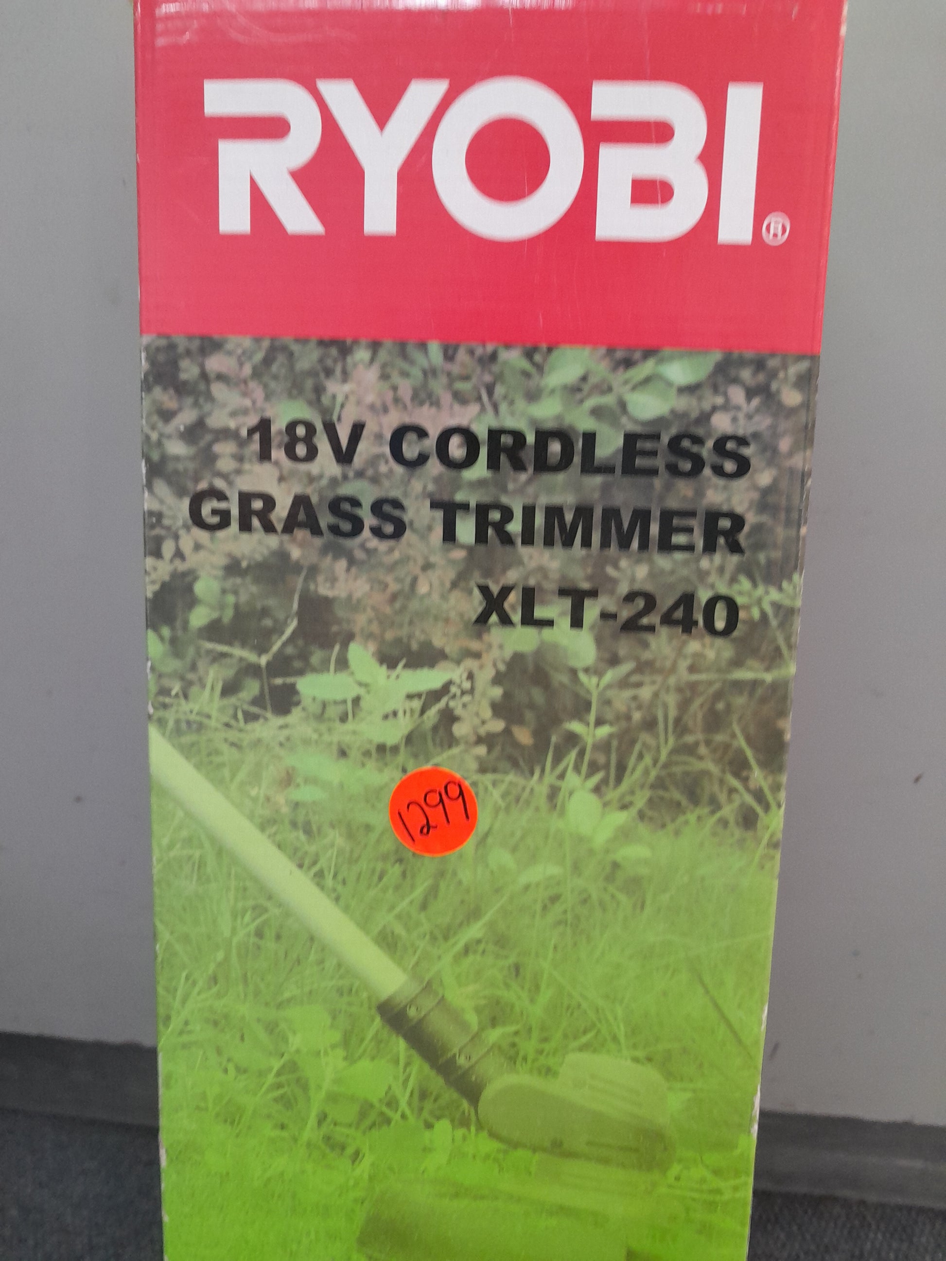 Ryobi 18V Cordless Grass Trimmer XLT-240 in original packaging with red branding and detailed features, available at Die Skatkis online secondhand store.