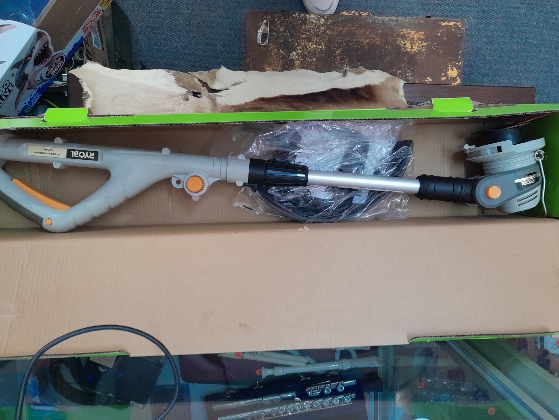 Ryobi 18V Cordless Trimmer (OLT1832), partially assembled in open packaging, available at Die Skatkis online secondhand store.