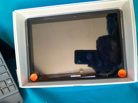 Samsung Galaxy Tab 2 10.1 in original packaging, labeled with orange stickers for 'PPA' and 'Sim,' reflection of person holding phone, available at Die Skatkis.