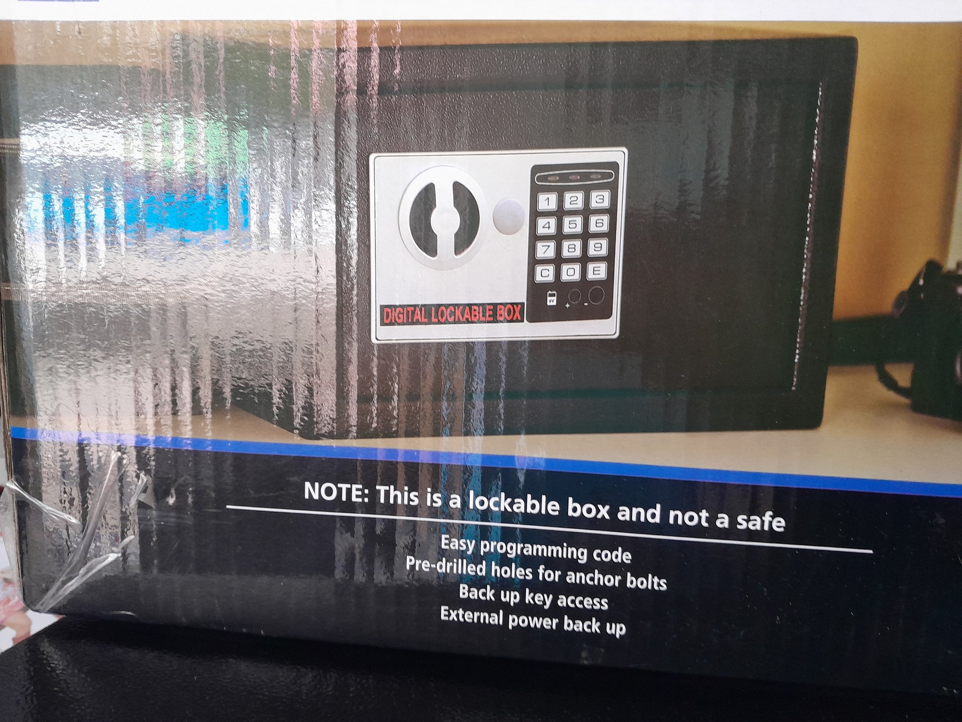Close-up of Mainstays digital lockable box keypad, showcasing easy programming and backup key access.