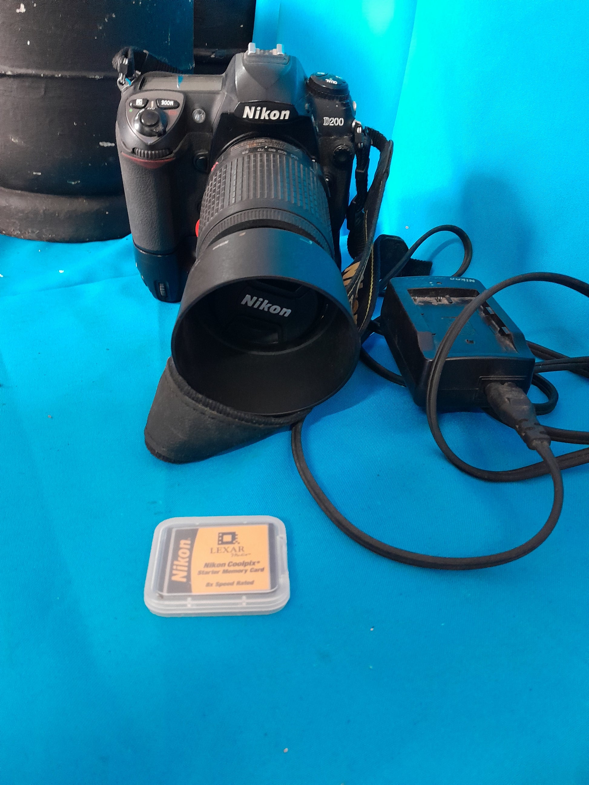 Quality Nikon D200 photography gear including lens and memory card, available in secondhand store.
