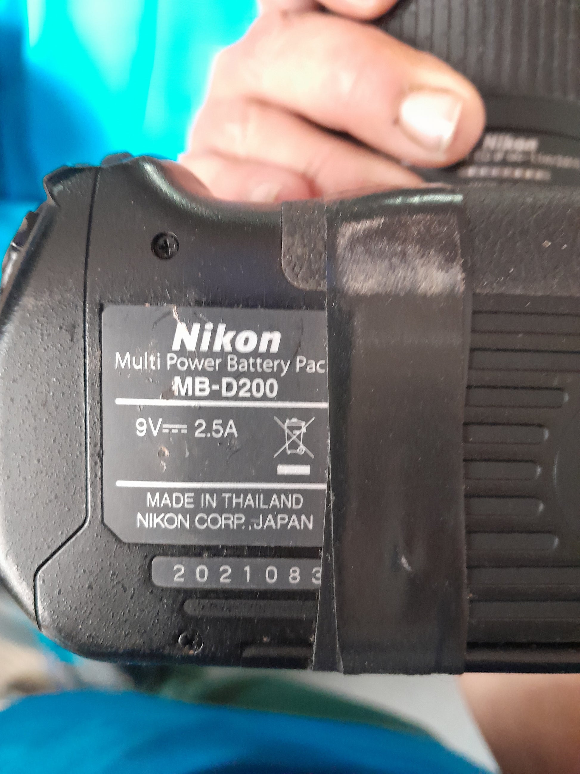 Nikon D200 camera with battery pack and lens, a great choice for secondhand photography gear.