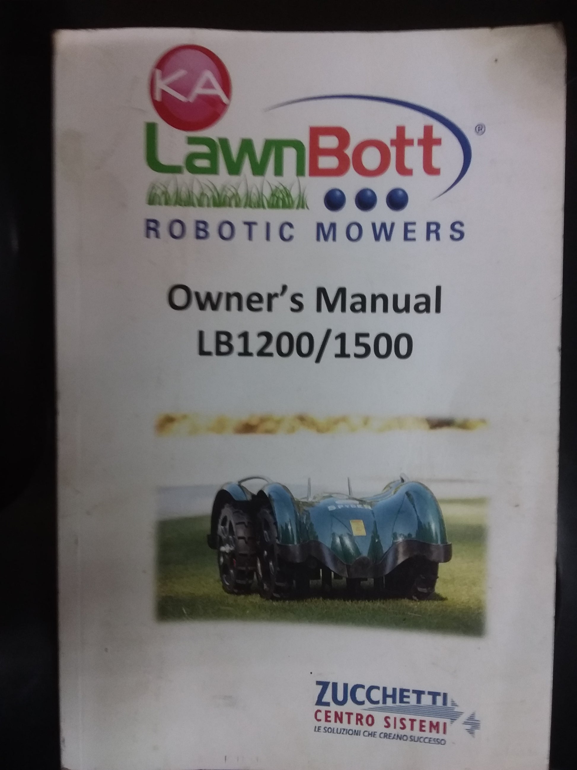 Owner's manual cover for the LawnBott LB1200/1500 robotic mowers by Zucchetti, featuring the LawnBott logo and mower image. Available at Die Skatkis.