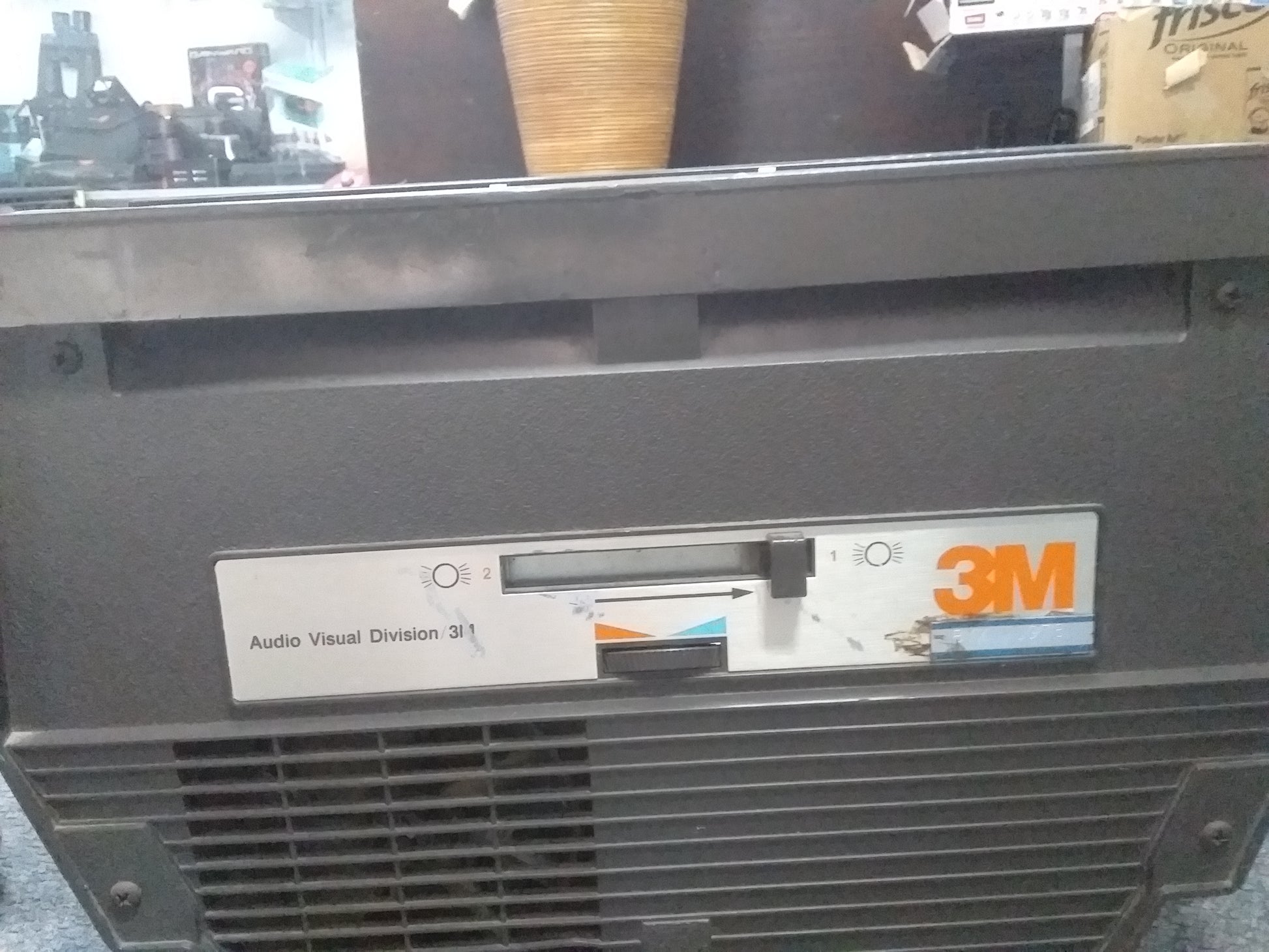 Close-up of a vintage 3M overhead projector, Audio Visual Division model, showing two-position switch and 3M logo. Available at Die Skatkis.