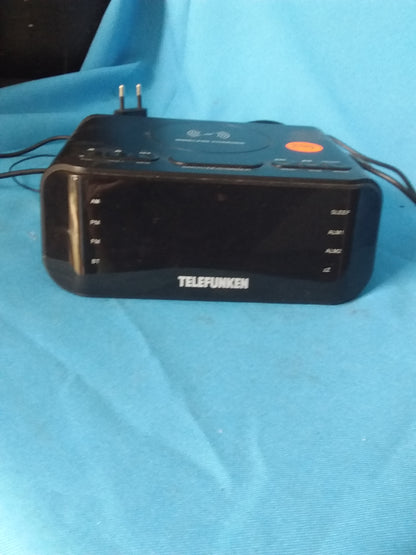 Telefunken digital clock radio with built-in wireless charger, featuring multiple alarm settings and sleek black design. Available at Die Skatkis.