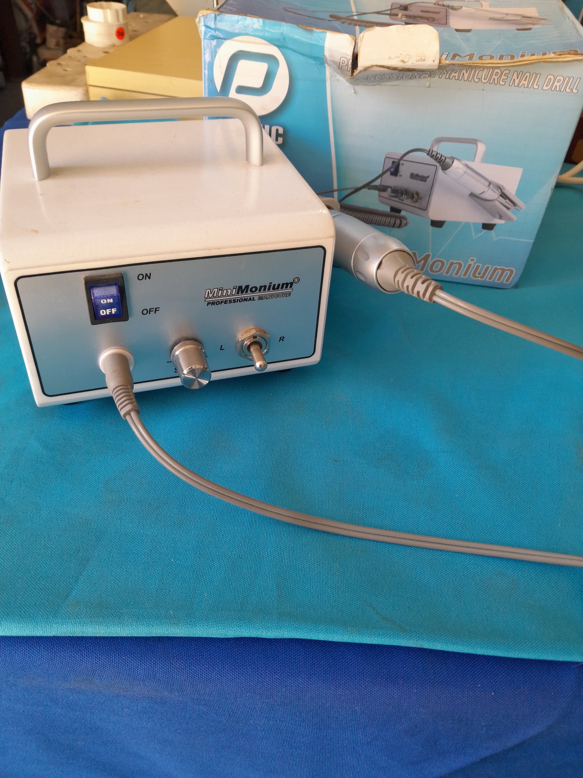 MiniMonium nail drill on a colorful background, ideal for professional nail care.