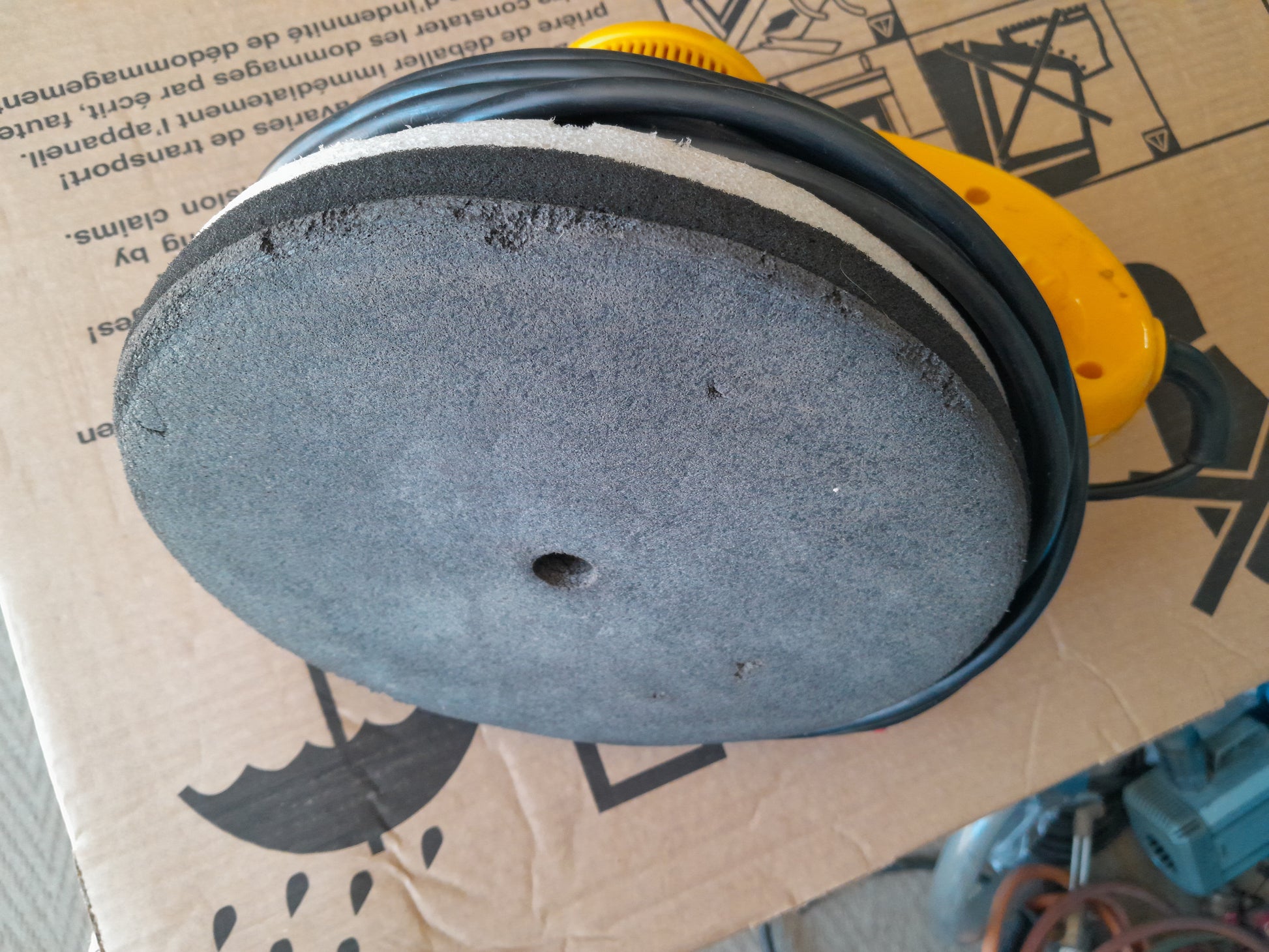 Close-up of the polishing pad on a Shield Orbital Polisher, highlighting its texture and condition.